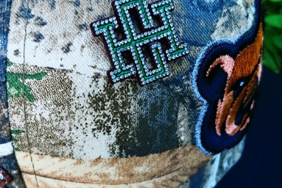 Detailed view of custom enamel hat pin design with multiple colors and finishes