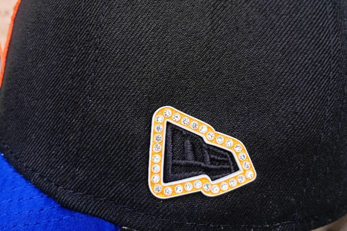 Detailed view of custom enamel hat pin design with multiple colors and finishes