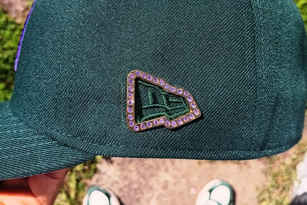 Detailed view of custom enamel hat pin design with multiple colors and finishes