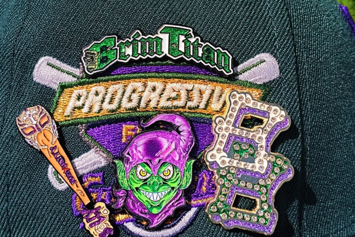 Detailed view of custom enamel hat pin design with multiple colors and finishes